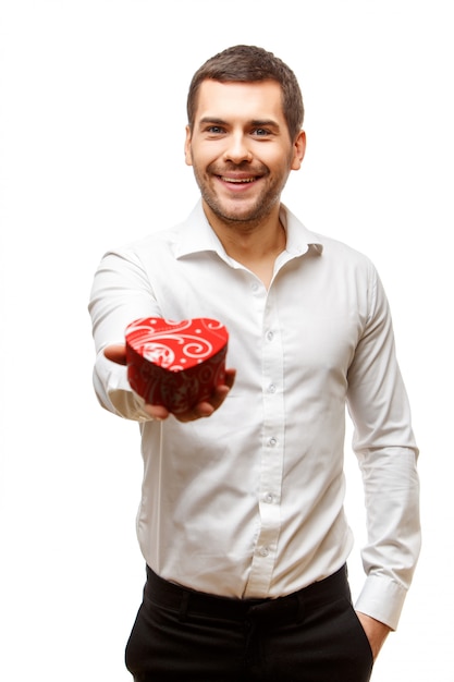 Young man carrying heart shaped box