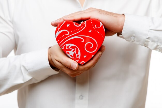 Young man carrying heart shaped box