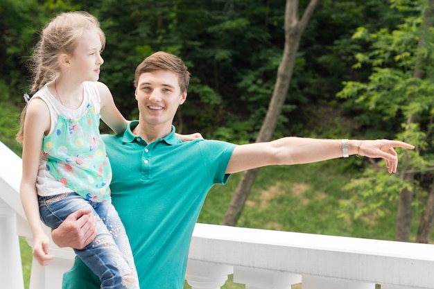 Young man carrying his sister and pointing