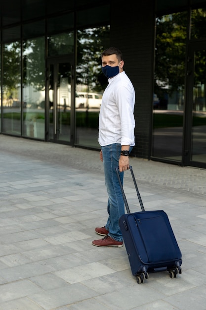 Young man carrying a luggage