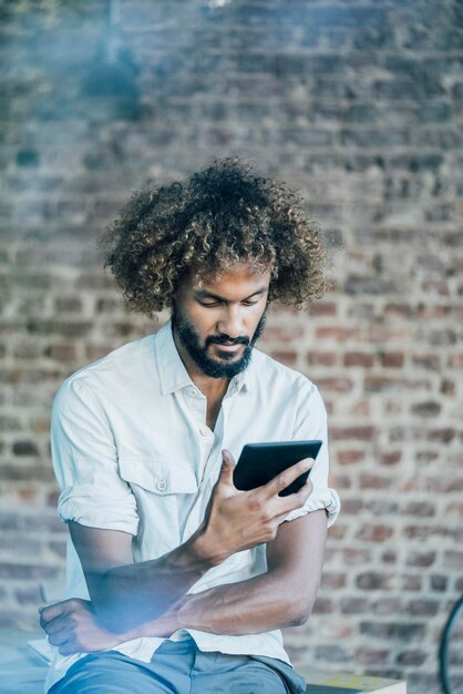 Young man checking his tablet