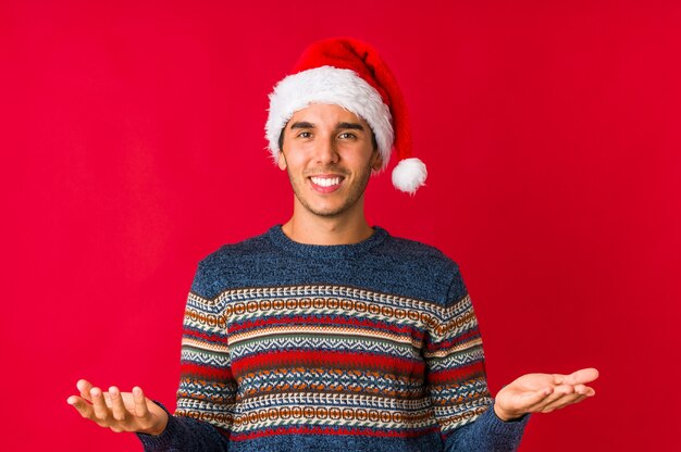 Young man on christmas day crossing fingers for having luck