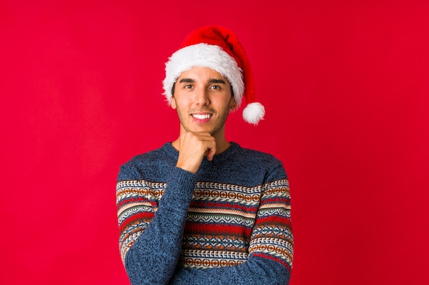 Young man on christmas day doubting between two options.