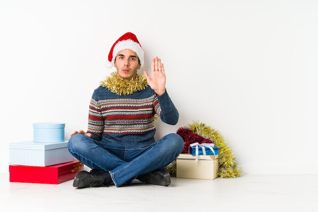 Young man on christmas day shouting towards a copy space