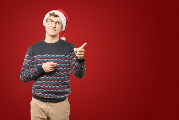 クリスマスのジェスチャーをしている若い男