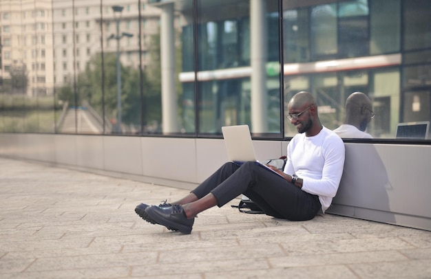 young man in the city wirh a laptop