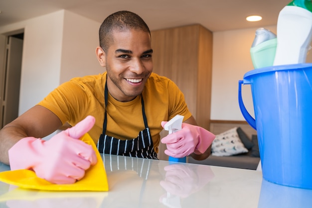 Young man cleaning at home