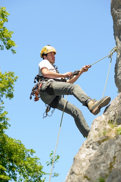 Young man climbing a rock wall