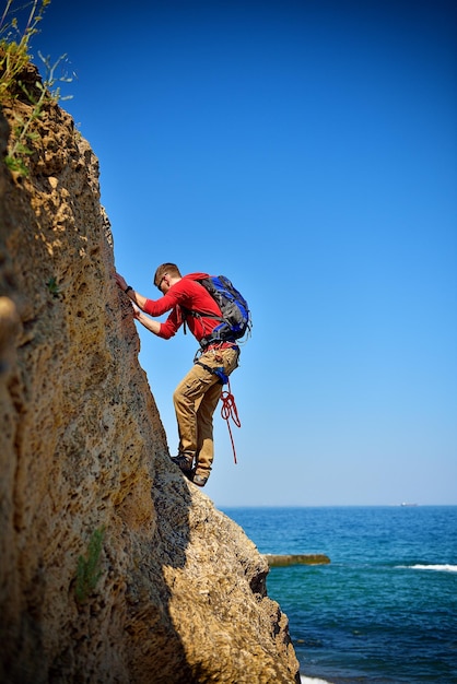 Young man climbing up