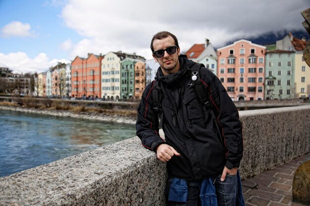 A young man in the colorful house near the river in the city of Innsbruck Austria