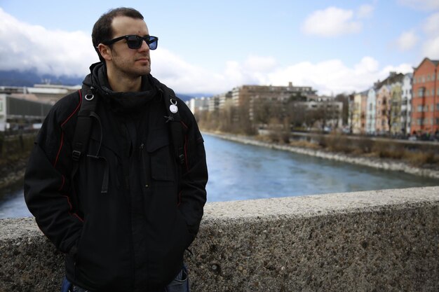 A young man in the colorful house near the river in the city of Innsbruck Austria