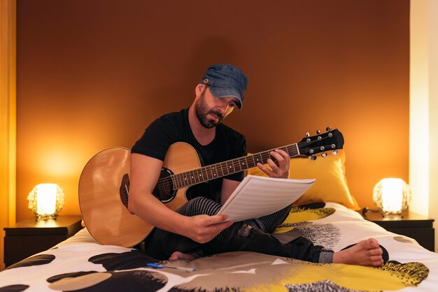 Young man composing music in his mome.