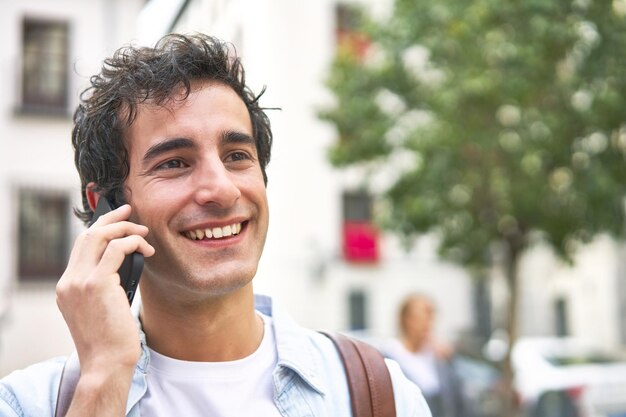 Young man confidently takes on the day engaging in a productive phone call while en route to work