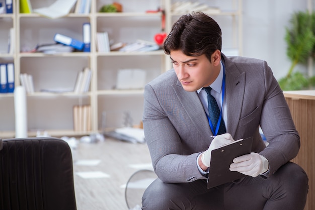 Young man during crime investigation in office