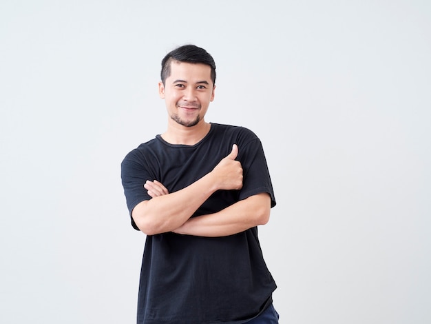 Young man crossed arms while standing.