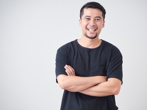 Young man crossed arms while standing.