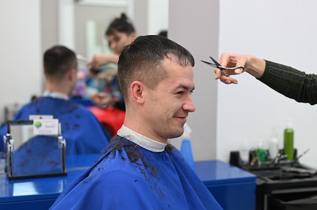 The young man cut his hair at the hairdresser. haircut at the hairdresser. Barbershop