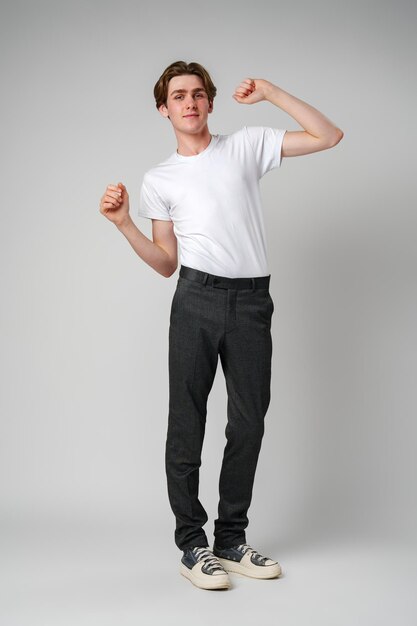 Young man dancing alone in a studio showing off casual moves