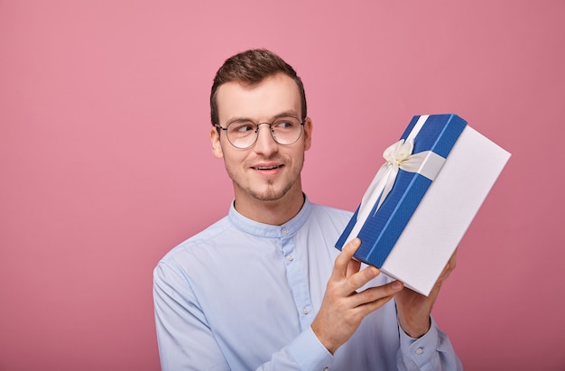 A young man in a delicately blue shirt with surprise