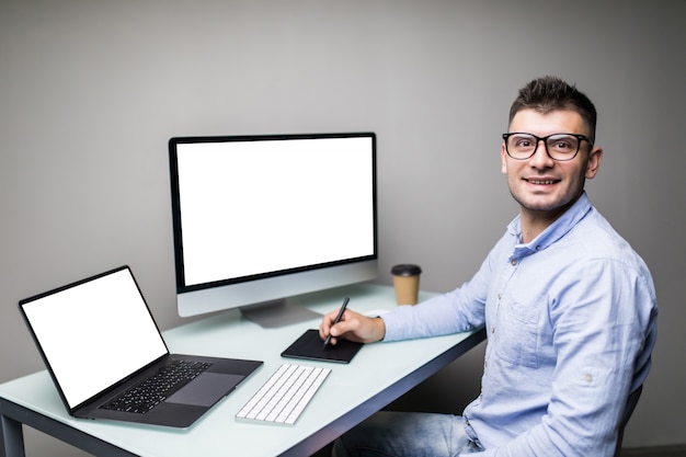 Young man designer editing photo on computer in office