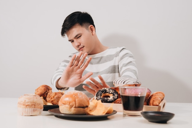 Young man in dieting and healthy eating concept