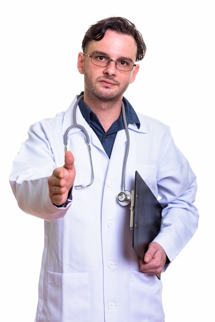 young man doctor holding clipboard while giving handshake