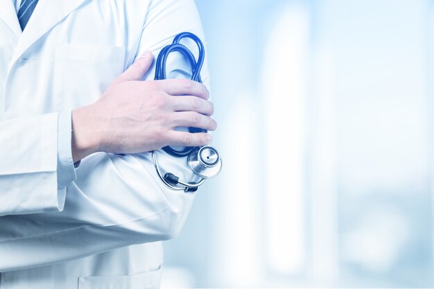 Young man doctor holding stethoscope