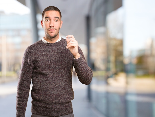 Young man doing a doubt gesture