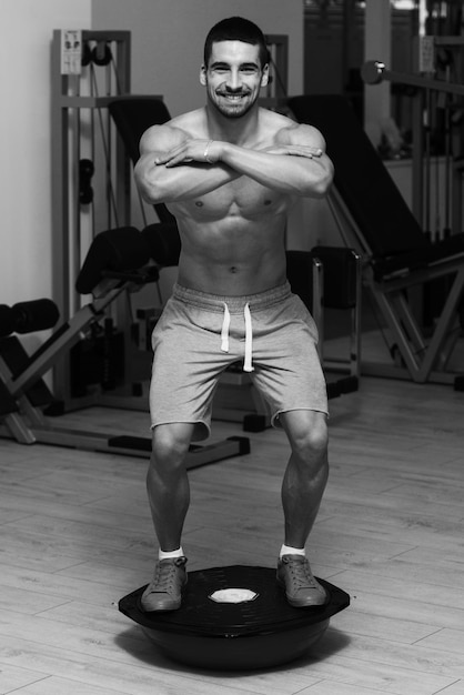 Young Man Doing Exercise  Bosu Balance Ball