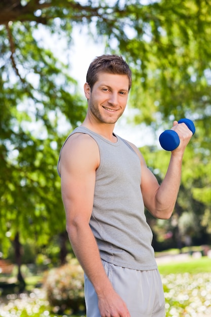 Young man doing his exercises in the park