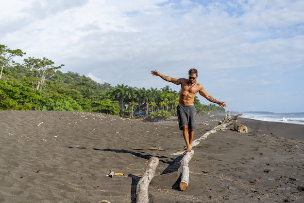 Young man doing a running workout at the beach