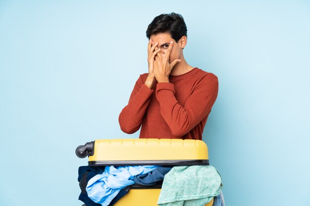 Young man doing suitcase