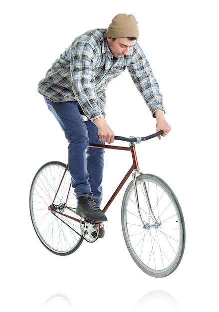 Photo young man doing tricks on a bicycle on a white