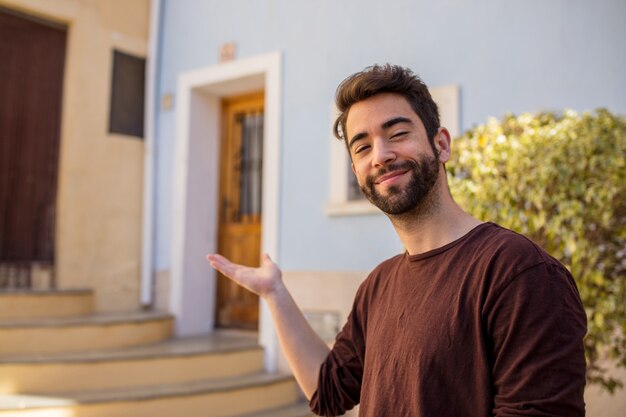 Young man doing welcome gesture