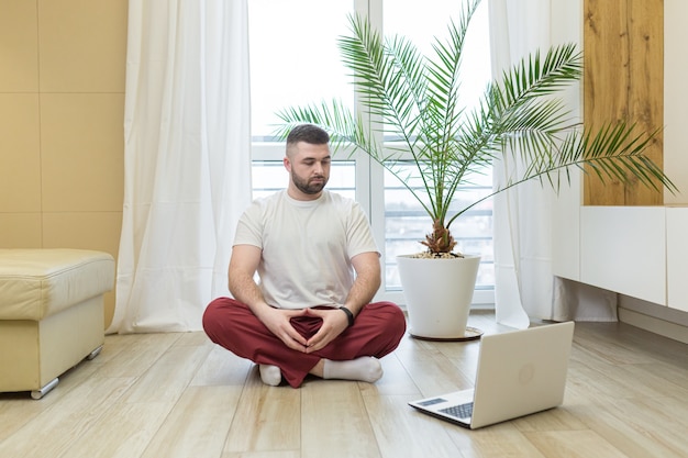 Young man doing yoga at home