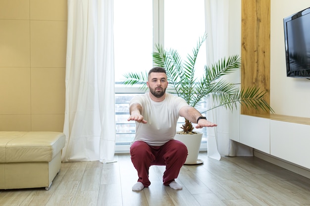 Young man doing yoga at home