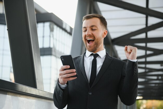 Young man dressed formal enjoying his success Winner concept