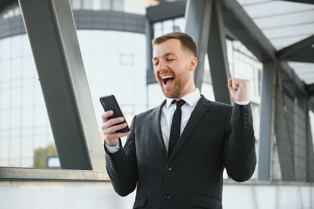 Young man dressed formal enjoying his success Winner concept