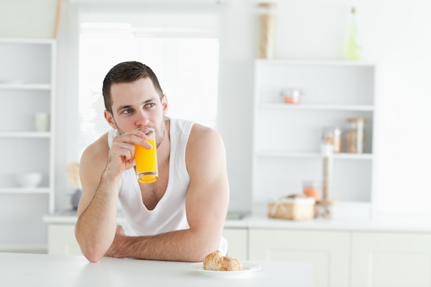 Young man drinking orange juice