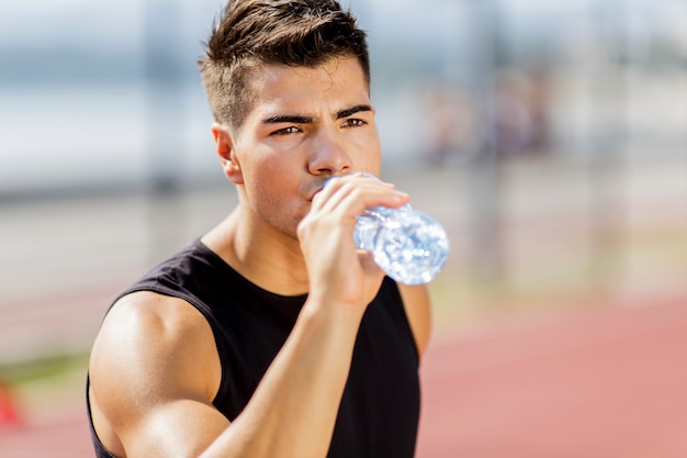 Young man drinking water