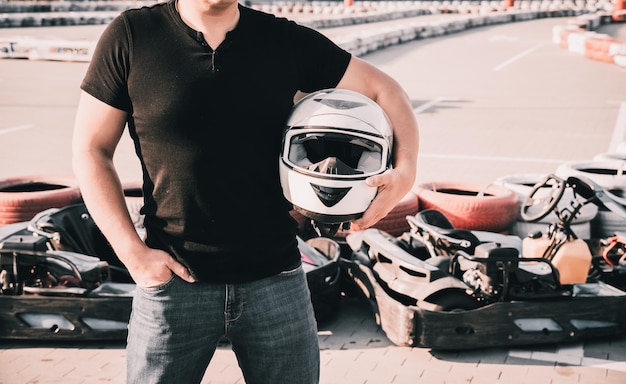 A young man drives a go kart at circuit