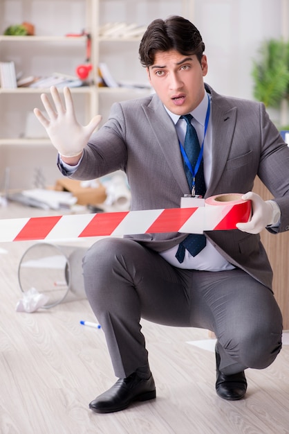 Photo young man during crime investigation in office