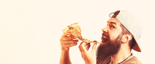 Young man eating pizza on white background Young fashion fun hipster guy eating pizza