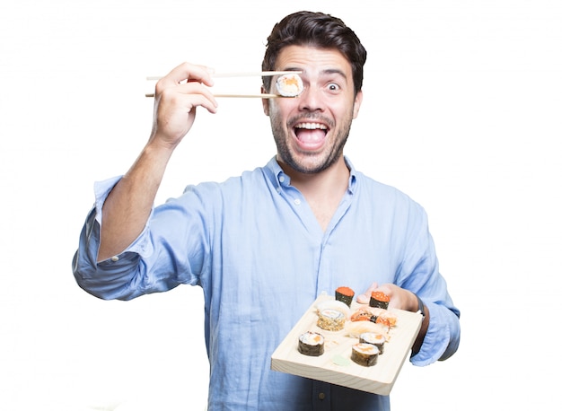 Photo young man eating sushi on white background