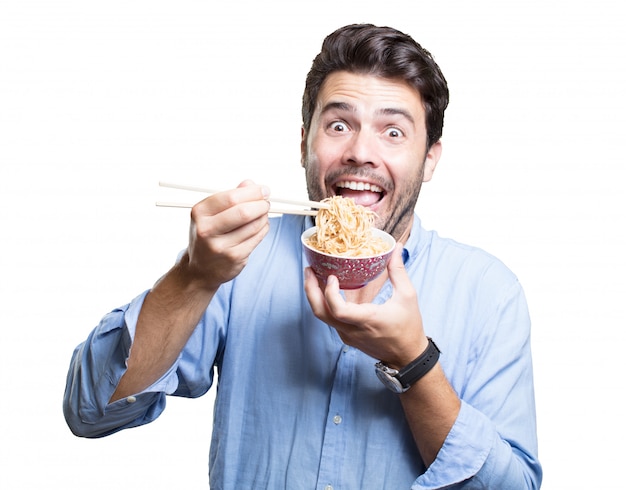 Young man eating sushi on white background