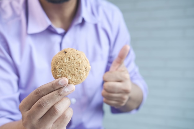 Young man eating whole meal cookies