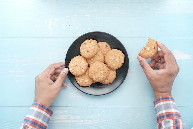 Young man eating whole meal cookies