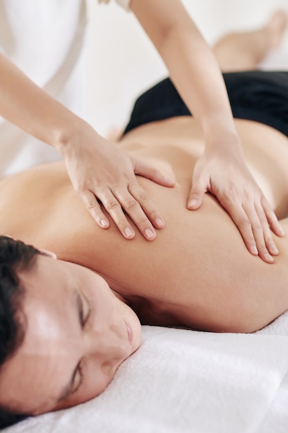 Young man enjoying back massage