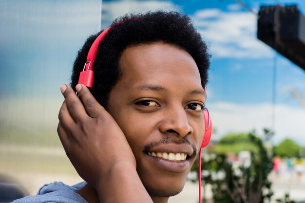 Young man enjoying music outdoor 