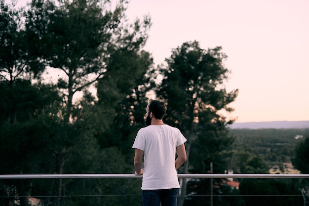 A young man enjoying the scenery in his forest home